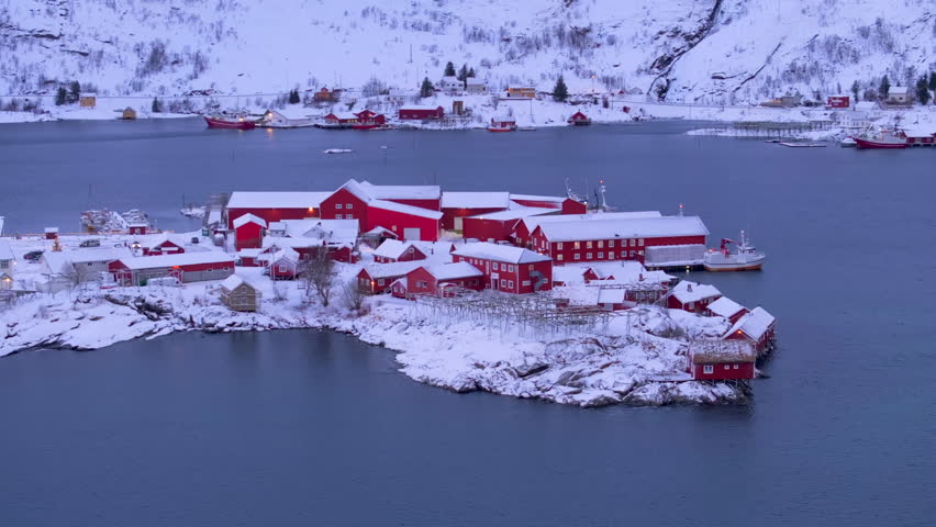 Aerial view of Hamnoy, a picturesque fishing village in the Lofoten Islands, Norway, showcasing red cabin fish factory set against breathtaking winter landscape