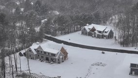 Two similar snow-covered mansion in rural suburb district of american town. Snowstorm in forest landscape. Aerial view. Snow-capped yard during blizzard. - Powered by Shutterstock - Get 15% off with code: PIKWIZARD15