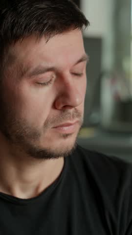 Tired man rubbing his eyes and pinching bridge of his nose. Close up of male face showing signs of stress, fatigue, or headache..Concept of exhaustion, overwork, mental health or everyday struggles