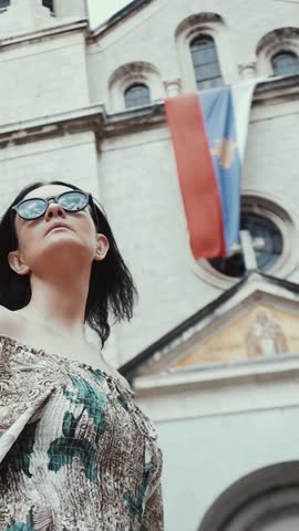 Beautiful woman in vintage old style city, laughing, walking and dancing on a background of the old city Kotor,Montenegro .