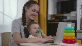 Child play meets home work. Mother and baby enjoy work and play. Home office with child playtime. Work life balance mom works child plays. Cheerful work from home atmosphere with playful child. - Powered by Shutterstock - Get 15% off with code: PIKWIZARD15