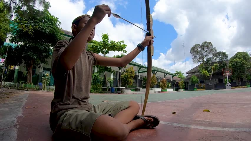 Young athletes practicing and training archery. Target practice. Shot in Slow Motion. Jemparingan archer.