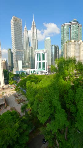 Cinematic FPV drone flight in downtown Kuala Lumpur on sunny day, Malaysia