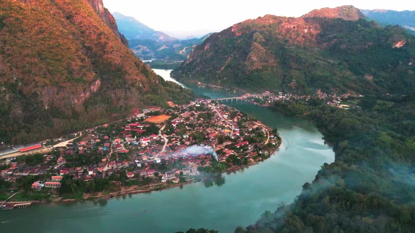Landscape of Nong Khiaw village in Laos Aerial view above river across mountains in Southeast Asia