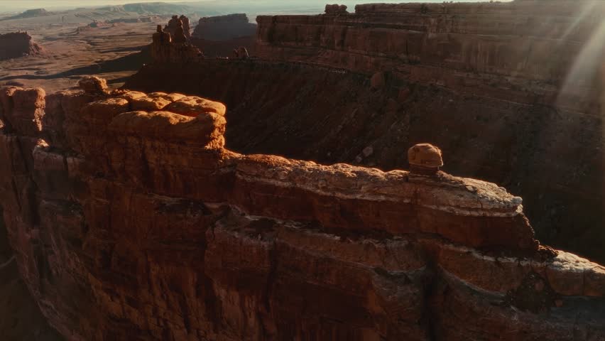 4K Aerial drone footage traveling along massive butte rock formation in Valley of the Gods Monument Valley, Utah