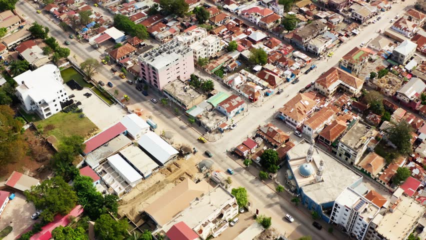Aerial shot showing a cityscape of Banjul, with road crossing, poor housing and a mosque in Banjul Gambia