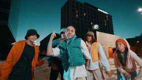 Young woman having fun dancing with group of friends in music street party in the city at night. Freedom and expression - Powered by Shutterstock - Get 15% off with code: PIKWIZARD15