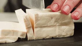 Fried tofu with sesame seeds and spices on cast iron pan, cooking japanese salad. Healthy ingredient for cooking vegan vegetarian diet food. Roasted tofu over black background. - Powered by Shutterstock - Get 15% off with code: PIKWIZARD15