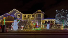 Snowman Santa Clause house Christmas trees Happy Holidays decoration Highlands Ranch Denver Colorado USA night time bright vibrant lights hanging home neighborhood slow pan left parallax motion - Powered by Shutterstock - Get 15% off with code: PIKWIZARD15