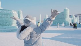 Young happy female tourist enjoying at ice and snow world festival in Harbin, China - Powered by Shutterstock - Get 15% off with code: PIKWIZARD15