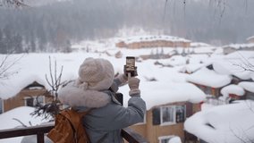 Young happy woman tourist taking photo and enjoying full of fluffy snow at China Snow town in winter
 - Powered by Shutterstock - Get 15% off with code: PIKWIZARD15