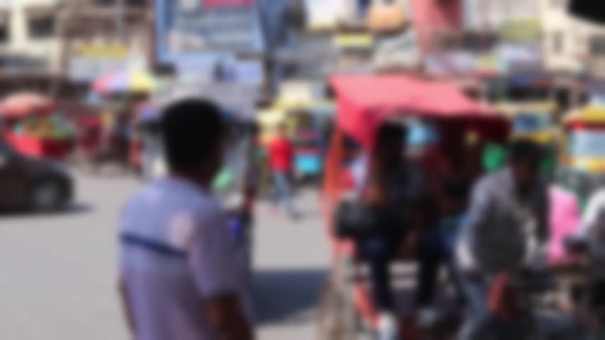 Blurred view of a busy intersection in the heart of Old Delhi. Chaotic movement of vehicles and pedestrians.