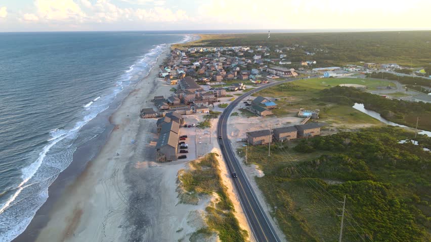 Sunset on Hatteras Island in North Carolina. Oceanfront, villas, and Cape Hatteras Lighthouse.
