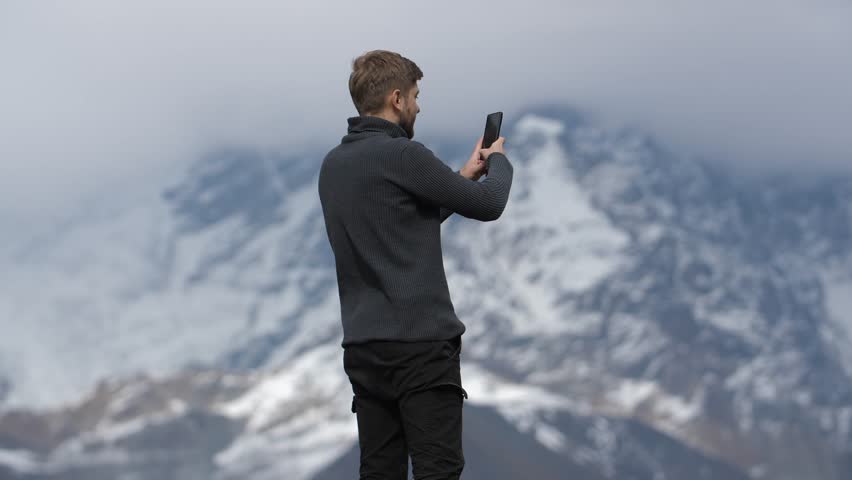 A man captures stunning mountain scenery on his phone