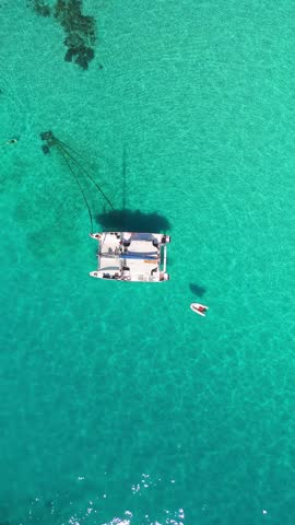 Aerial view of a sailboat on turquoise water over the great barrier reef, Queensland, Australia.