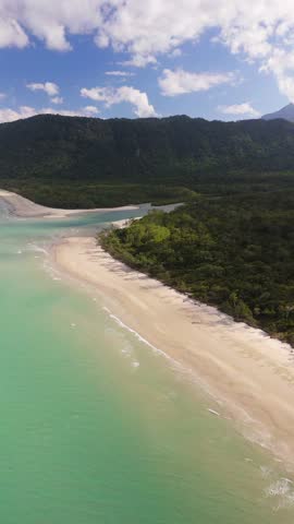 Aerial view of beautiful Noah Beach with clear turquoise waters and lush Daintree Forest, Queensland, Australia.