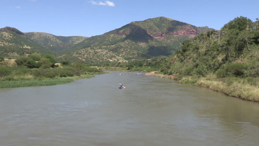 A wide shot of people in their white water rafts