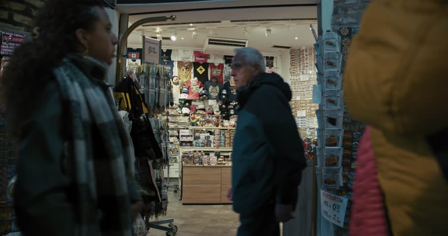 Vienna , Austria - 10 21 2024: Tourists browsing souvenir shop at night in Vienna city center