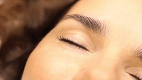 The make-up artist does eyelash lamination. She paints eyelashes, shapes eyebrows, curls eyelashes, applies dye and certain - Powered by Shutterstock - Get 15% off with code: PIKWIZARD15