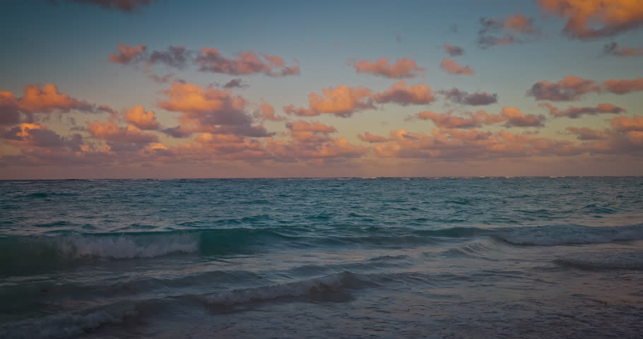 Sunrise with dramatic color cloudscape over Caribbean Sea and tropical island beach resort Punta Cana, Dominican Republic