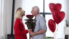old man senior giving flowers and heart-shaped balloons to his wife kissing, hugging and congratulating at home, elderly couple celebrating Valentine's Day and making romantic date - Powered by Shutterstock - Get 15% off with code: PIKWIZARD15