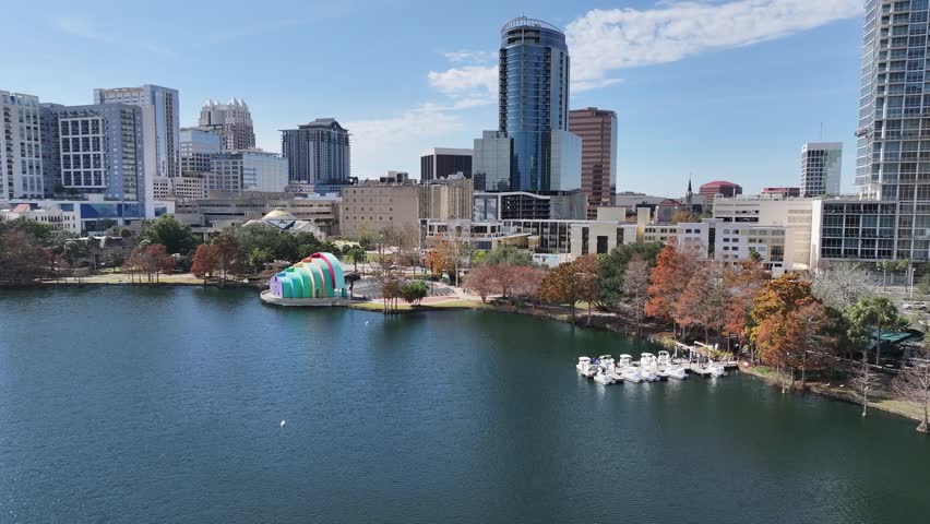 Orlando Skyline At Orlando Florida United States. Aerial View Of A Bustling Downtown Cityscape With Modern Buildings. Town Clouds Sky Backgrounds Urban. Town Outdoors Panning Wide. Orlando Florida.