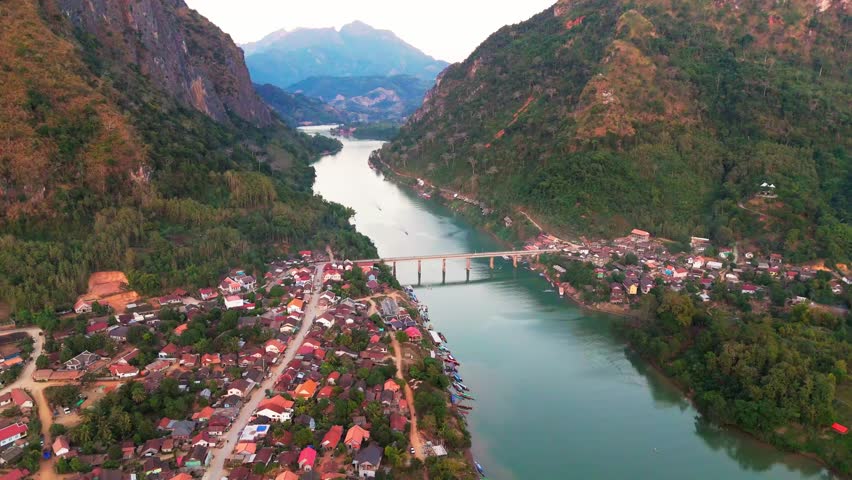 Scenic Aerial View at Laos Nong Khiaw rural village, bridge cross Nam Ou river, tropical southeast Asian landscape