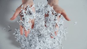 Shredded paper office documents in worker woman hands. Top down view - Powered by Shutterstock - Get 15% off with code: PIKWIZARD15