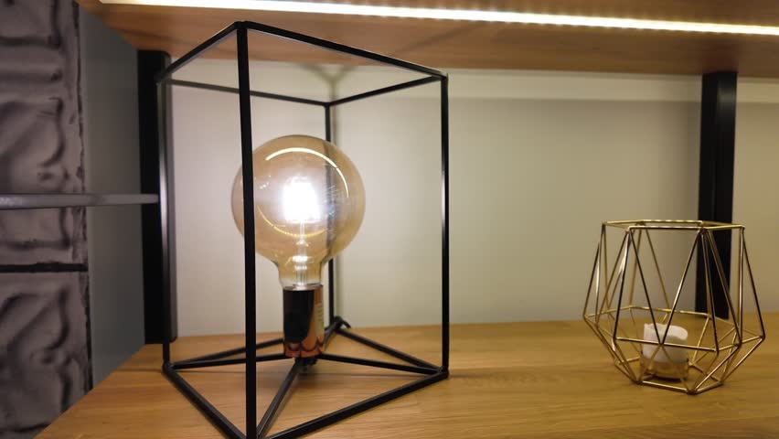 Close-up view about a geometrical and artistically designed table lamp in a room, France.
