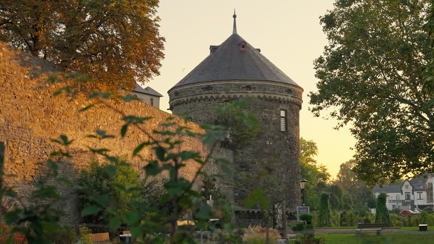 Old medieval tower wall during an early morning sunrise with parallax movement, Andernach, Rhine River Valley, Germany