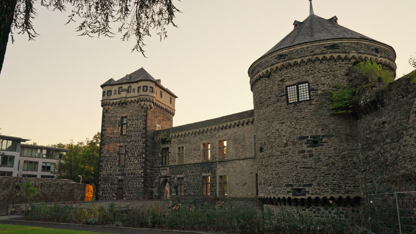 Medieval tower and fortress wall during a summer sunrise with parallax movement, Andernach, Rhine River Valley, Germany