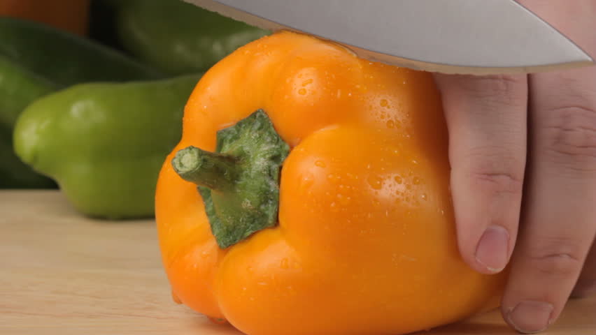 Cutting a yellow pepper, shot in HD video