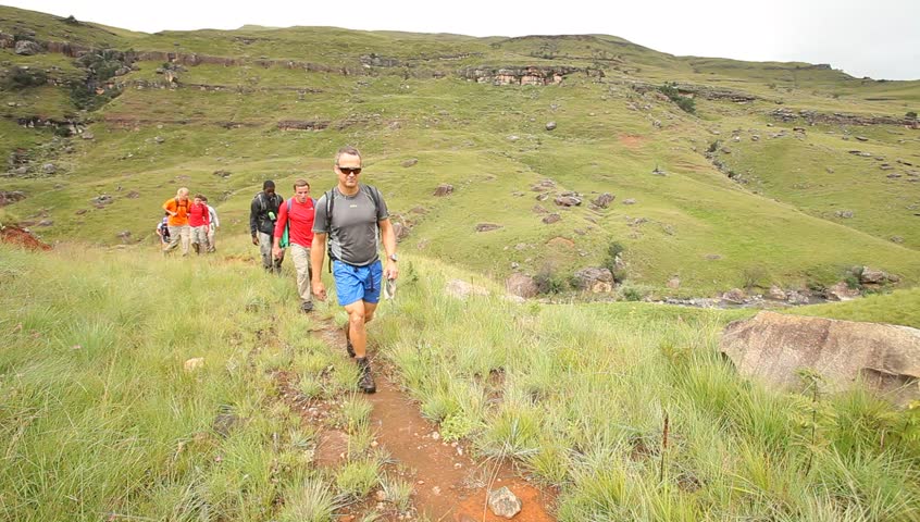 Young people hiking in the Drakensberg, the highest mountain range in Southern