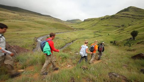 Young group hiking in the Drakensberg,  the highest mountain range in Southern Africa