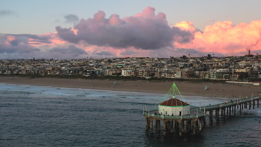 Roundhouse Aquarium At Manhattan Beach Pier With Waterfront City In California, USA. - aerial shot