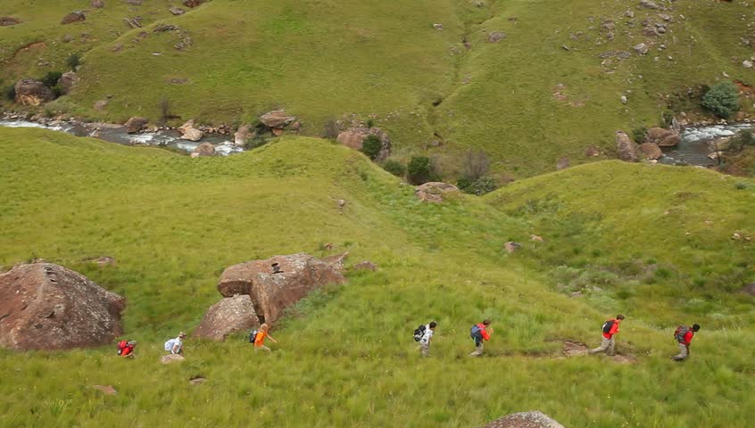 Wide shot of young hikers hiking in the Drakensberg