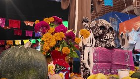 A table with a skull, flowers, and pumpkins. The skull is decorated with flowers and the table is decorated with colorful banners - Powered by Shutterstock - Get 15% off with code: PIKWIZARD15