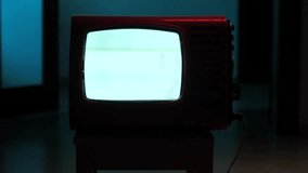 Old analog television showing static noise in dark room - Powered by Shutterstock - Get 15% off with code: PIKWIZARD15