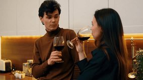 Couple enjoying wine while engaging in conversation at home - Powered by Shutterstock - Get 15% off with code: PIKWIZARD15