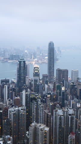 4k vertical sunset day to night scene at Hong Kong city skyline. Zoom out