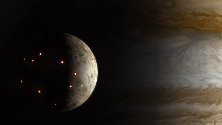Close Establishing Shot of the Volcanic Moon Io Emerging From the Shadow of the Gas Giant Jupiter