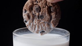 Hand Dipping A Chocolate Chip Cookie In A Cup Of Milk. - Powered by Shutterstock - Get 15% off with code: PIKWIZARD15