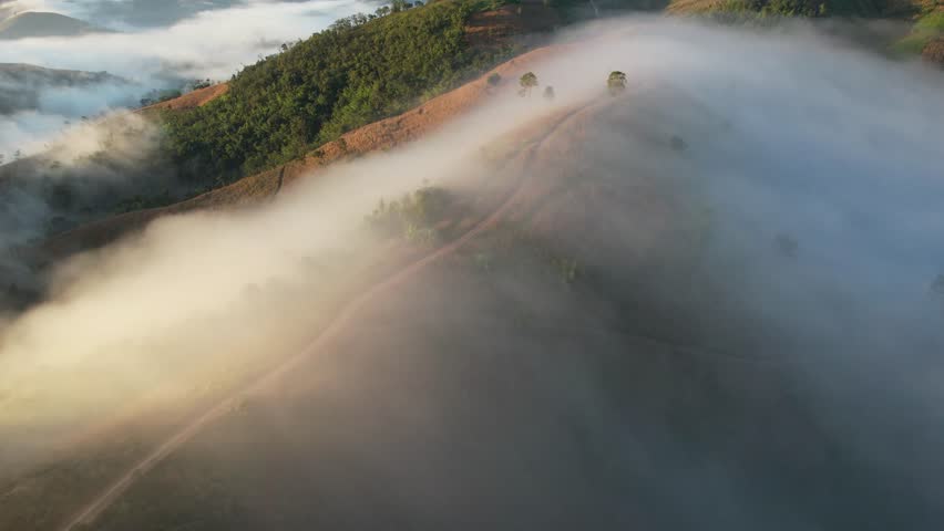 Aerial landscape view of the sea of fog flowing on hills