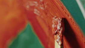 Brush coated in thick orange oil paint, creating textured strokes on canvas, painting abstract artwork. Extreme close-up shot - Powered by Shutterstock - Get 15% off with code: PIKWIZARD15