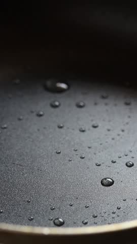 Cracked raw chicken egg into hot frying pan.