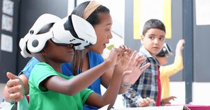 In school, boy using VR headset while teacher and classmate watching attentively. Education, technology, virtual reality, classroom, learning, digital, unaltered, slow motion - Powered by Shutterstock - Get 15% off with code: PIKWIZARD15