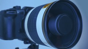 A professional camera on a tripod with a powerful mirror zoom lens that reflects the ring LED light. Closeup. Macro - Powered by Shutterstock - Get 15% off with code: PIKWIZARD15