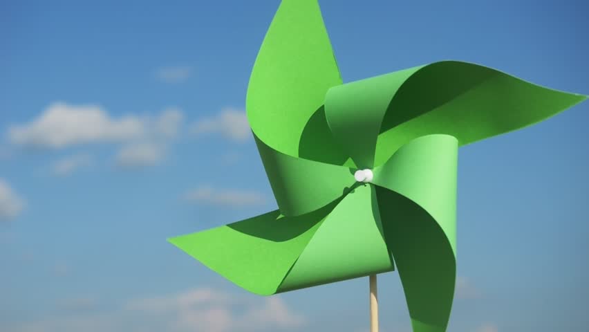 renewable energy concept vertical video. green paper pinwheel in hands against blue sky. World Environment Day. Recycling symbol. circular economy concept for environmental sustainability 