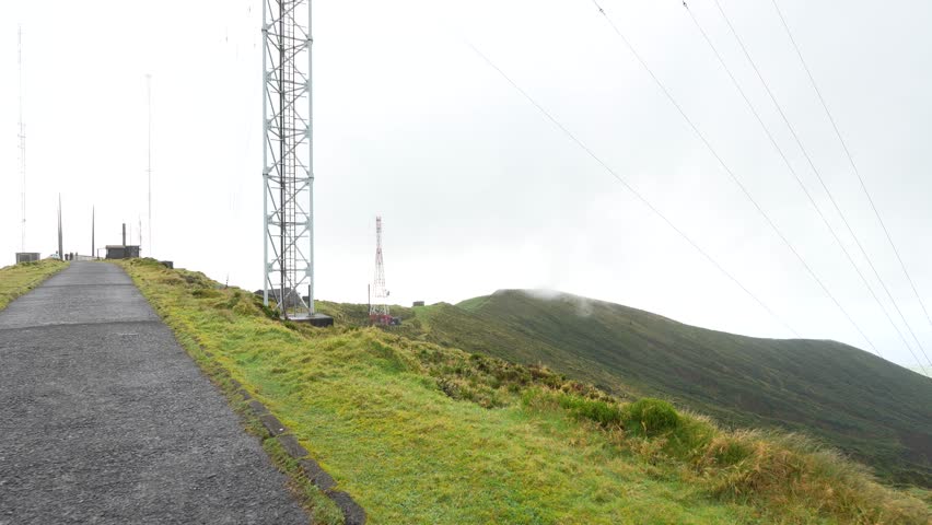 Road leading up to scenic view point of the Lagoa do fogo, crater lake on the Azores island, Portugal, misty view point, hiking routes.