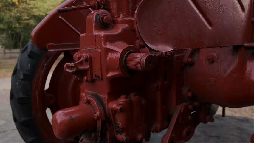 A red tractor in a forest area. Ideal for small land plots where high power is not required, providing efficient and reliable operation.